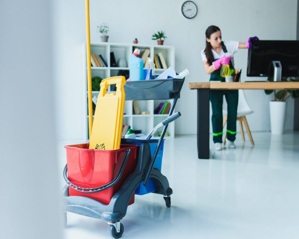 young-female-janitor-cleaning-office-with-various-cleaning-equipment.jpg young-female-janitor-cleaning-office-with-various-cleaning-equipment.jpg